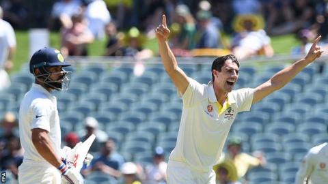 Pat Cummins celebrates taking the wicket of India captain Virat Kohli