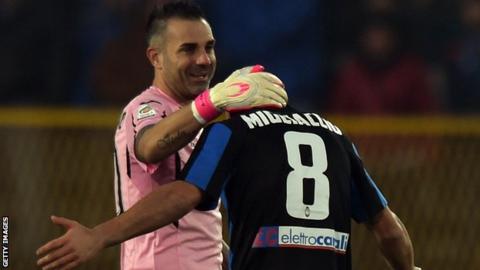 Atalanta midfielder Giulio Migliaccio receives the commiserations of Palermo goalkeeper Stefano Sorrentino after being sent off