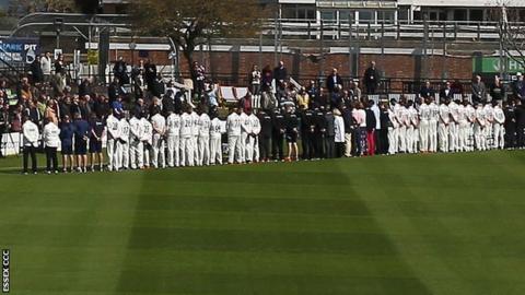 The Sussex and Essex players stood to observe a minute's silence before the start of play at Hove