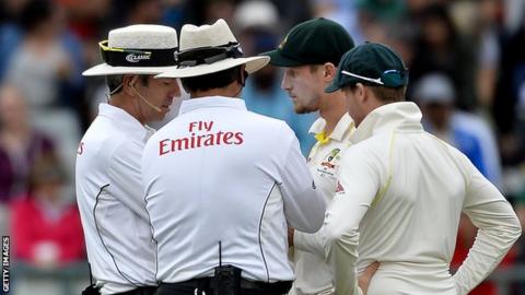 Umpires Nigel Llong and Richard Illingworth speak to Australia's Cameron Bancroft (second right) and captain Steve Smith