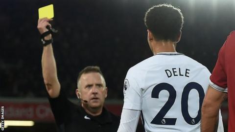 Dele Alli is booked by Jon Moss