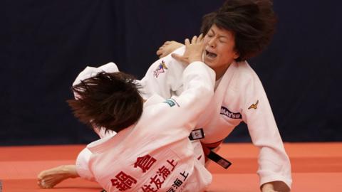 Miku Tashiro (R) and Nami Nabekura compete in the Women's -63kg final match during day one of the All Japan Judo Championships at the Fukuoka Convention Center.