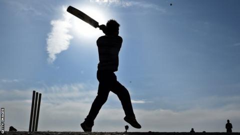 Cricket player in silhouette