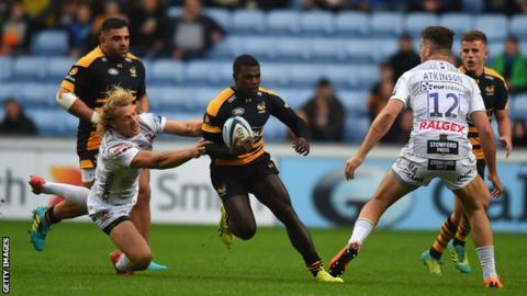 Christian Wade runs between a gap in the Gloucester defence while playing for former club Wasps