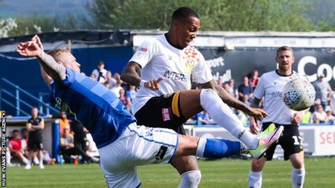 Keanu Marsh-Brown of Newport County and Elliott Durrell of Macclesfield Town compete for the ball