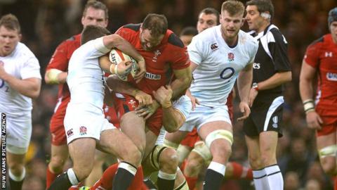 Jamie Roberts of Wales is tackled by George Ford and Ben Youngs