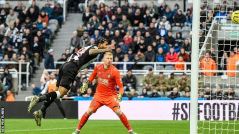 DeAndre Yedlin (left) scores