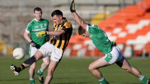 Crossmaglen's John Murtagh gets his shot away as Cargin opponent Anthony Scullion attempts a block