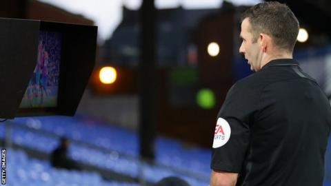 Referee Michael Oliver reviewing an incident on the pitchside monitor during Crystal Palace's FA Cup tie against Derby