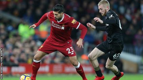Swansea's Oli McBurnie tussles with Emre Can of Liverpool