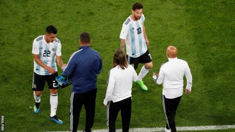 Lionel Messi walks to the touchline towards manager Jorge Sampaoli