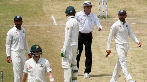 India captain Virat Kohli (right) looks at Australia counterpart Steve Smith as he walks off after being given out