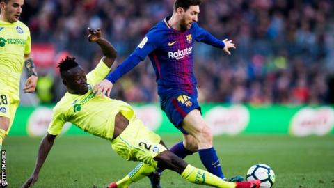 Togo's Dakonam Djene tackles Lionel Messi