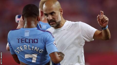 Pep Guardiola talks with Raheem Sterling after Manchester City's victory over West Ham United in the Premier League Asia Trophy