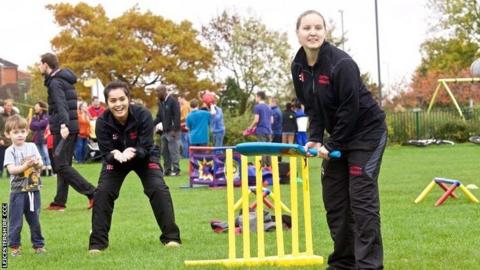 Wicketkeeper Amna Rafiq takes part in a community cricket match