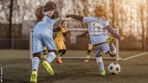 Young girls playing football