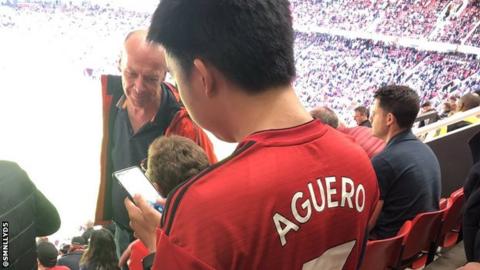 A Manchester United fan wearing an Aguero shirt at Old Trafford.