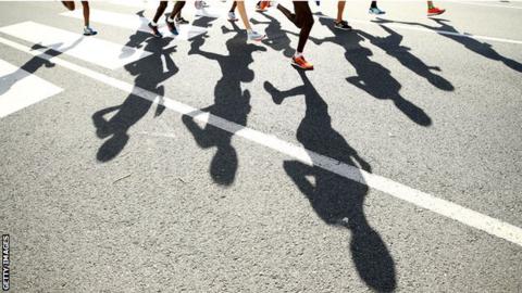 Shadow of athletes running