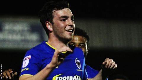 Sean Kelly celebrates his goal for AFC Wimbledon against Rochdale