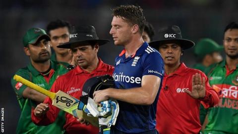 Jos Buttler (centre) walks off after being dismissed against Bangladesh