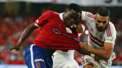 Zamalek's Ahmed Dwedar (right) vies with Al Ahly's Malik Evona