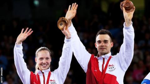 Chris and Gabby Adcock celebrate with Commonwealth medals
