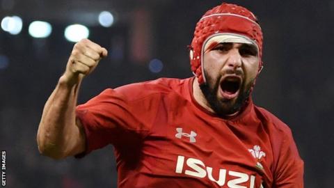 Cory Hill punches the air and bellows after scoring a try for Wales against England