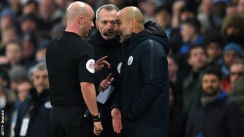Referee Anthony Taylor (left) speaks to Manchester City boss Pep Guardiola (right) as fourth official Martin Atkinson (centre) looks on during City's 2-1 win over Liverpool