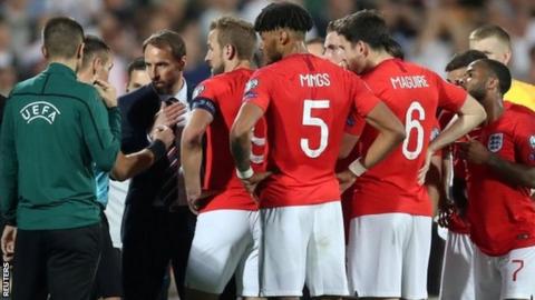 England players speak to Uefa officials during the game in Sofia