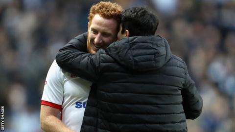 Dean Lewington (left) shares an embrace with new MK Dons boss Dan Micciche