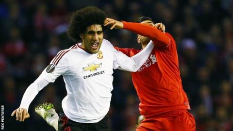 Marouane Fellaini (left) challenges with Emre Can (right)