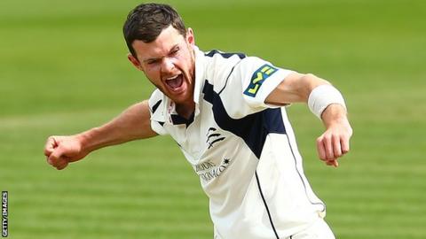 Middlesex bowler James Harris celebrates taking a wicket