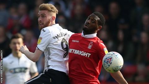 Oli McBurnie of Swansea City is challenged by Molla Wague of Nottingham Forest