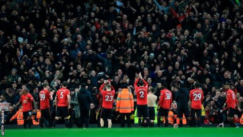 Manchester United players applaud the crowd after their game with Manchester City in December