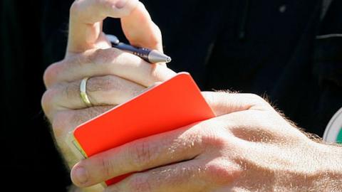 Referee with a red card