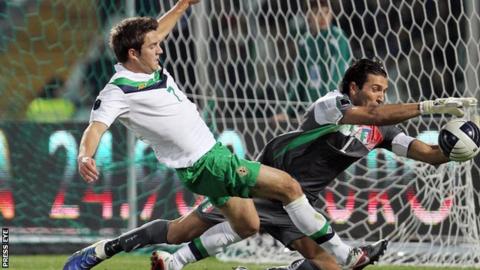 Andrew Little in action for NI against legendary Italian goalkeeper Gianluigi Buffon in October 2011