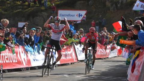 Tadej Pogacar celebrates victory on stage 13