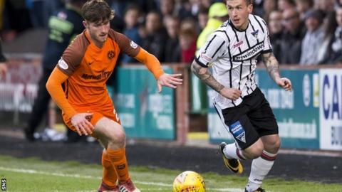 Dunfermline's Fraser Aird (right) takes on Dundee United's Anthony Ralston