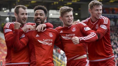 Aberdeen players celebrate Shay Logan's goal