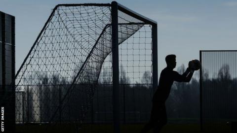 Silhouette image of a goalkeeper
