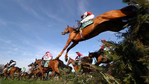 Sam Coltherd riding Captain Redbeard clears the Canal Turn during the Grand National at Aintree Racecourse