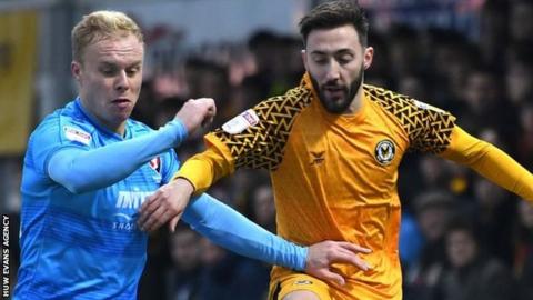 Newport County's Josh Sheehan (right) is tackled by Cheltenham's Ryan Broom