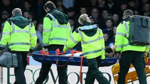 Nikos Karelis is stretchered off