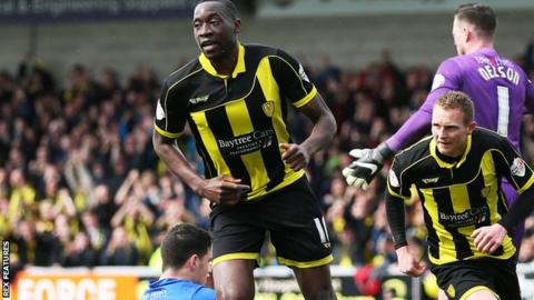 Burton's Lucas Akins celebrates scoring the opening goal against Gillingham