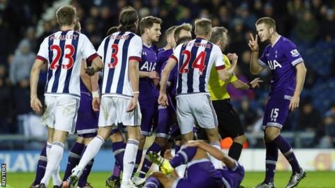 West Brom and Spurs players surround the referee