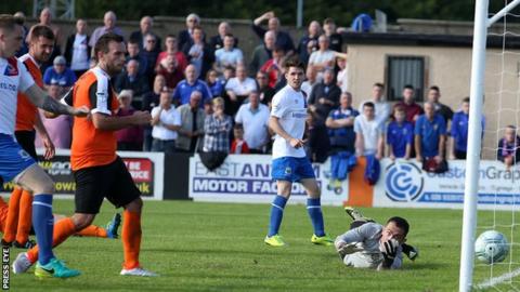 Ross Gaynor's cross sneaks inside the post to put the Blues ahead at Carrick
