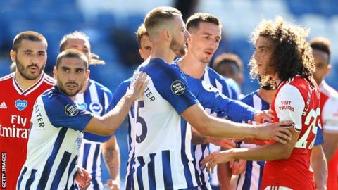 Neal Maupay is confronted by Matteo Guendouzi