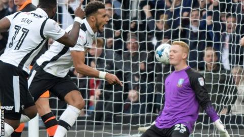 Derby's Cyrus Christie celebrates goals against Sheffield Wednesday