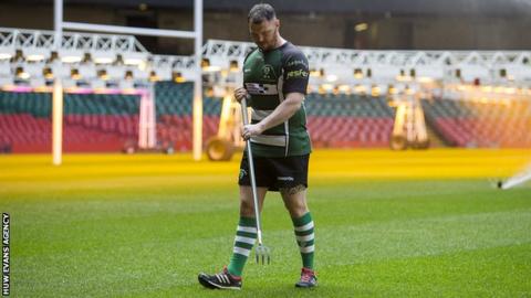 Rhys Cleverly works on the Principality Stadium pitch while wearing Caerphilly kit