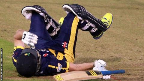 Graham Wagg falls to the ground after being struck on the head